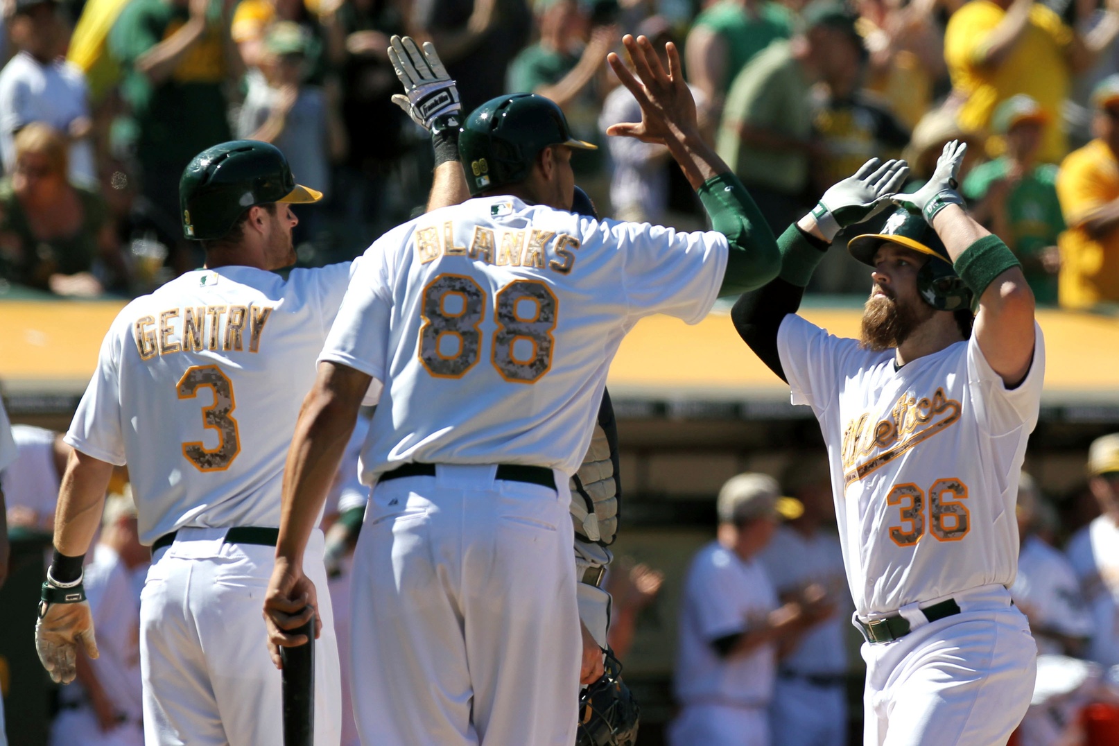 The Oakland Athletics' Yoenis Cespedes, right, is greeted at home